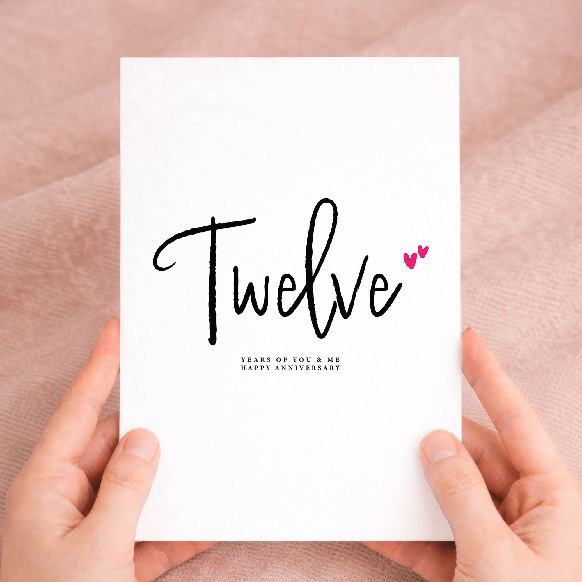 A simple and romantic 12th wedding anniversary greeting card featuring a clean design with letters and numbers on a white background.