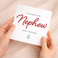 A festive Christmas greeting card for a nephew featuring the text Best Nephew Ever in a Letters and Numbers design on a white background.