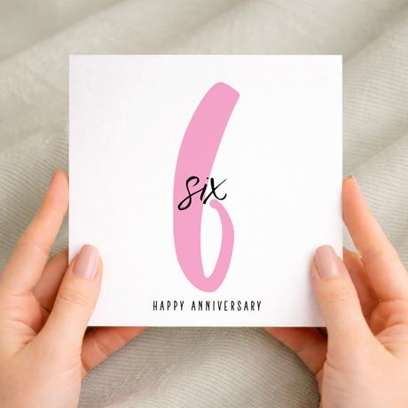 A 6th wedding anniversary greeting card featuring a simple design with the number 6 on a textured, eco-friendly recycled card.