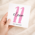 A simple 11th wedding anniversary greeting card for him or her featuring a minimalist design on a white background.