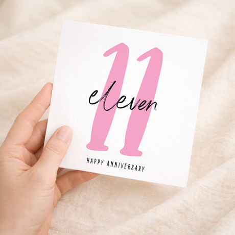 A simple 11th wedding anniversary greeting card for him or her featuring a minimalist design on a white background.
