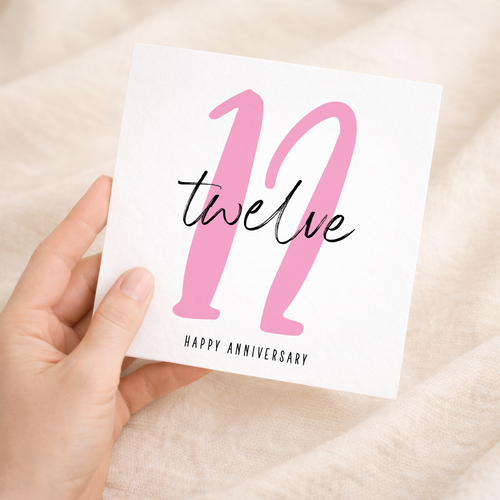 A simple 12th wedding anniversary greeting card for a husband or wife featuring a letters and numbers design on a white background.