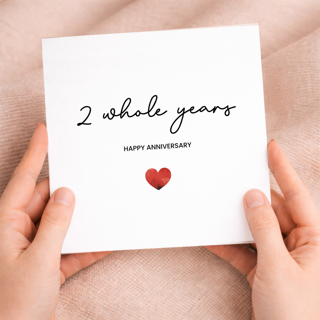 A simple and charming 2nd anniversary greeting card featuring a modern love heart design on a white background.