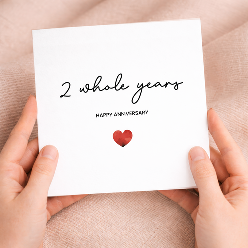 A simple and charming 2nd anniversary greeting card featuring a modern love heart design on a white background.
