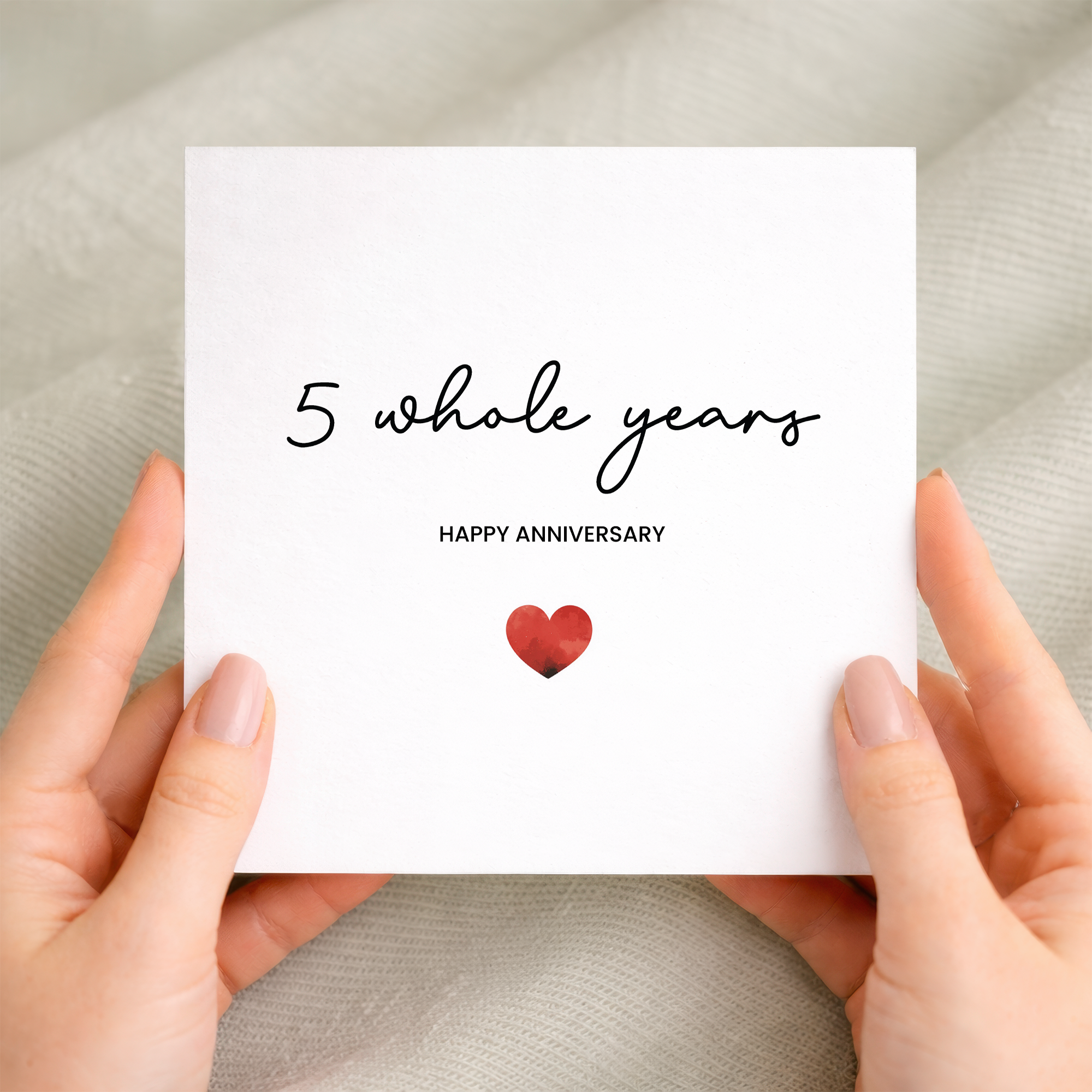 A simple and modern 5th anniversary greeting card featuring a charming love heart design on a white background.