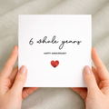 A simple and modern 6th anniversary greeting card featuring a red love heart design on a white background.