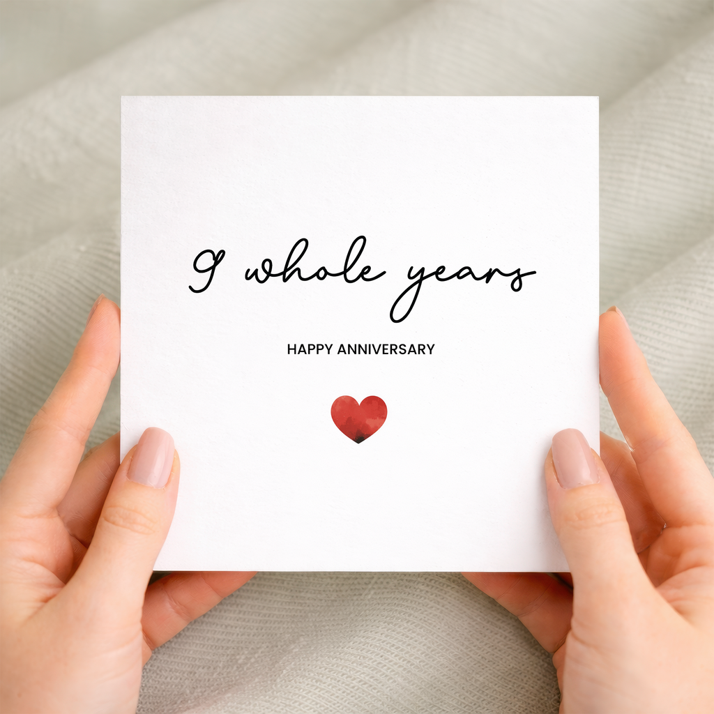 A simple and modern 9th anniversary greeting card featuring an elegant love heart design in red, white, and black.