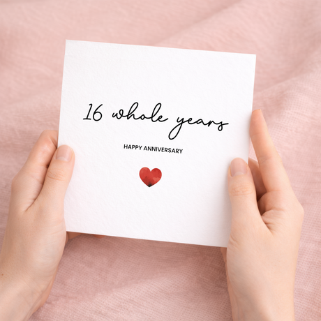 Minimalist 16th anniversary greeting card featuring a simple red heart design on a white background with a brown kraft envelope.