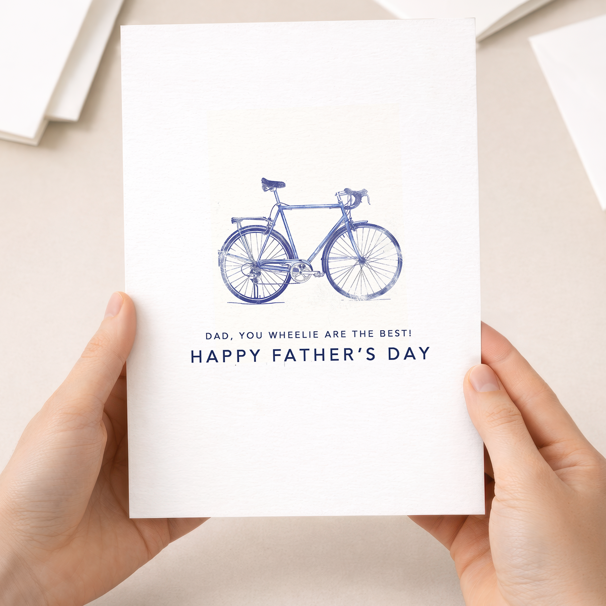 Father's Day greeting card with a minimalist blue bicycle illustration and the pun You wheelie are the best dad.