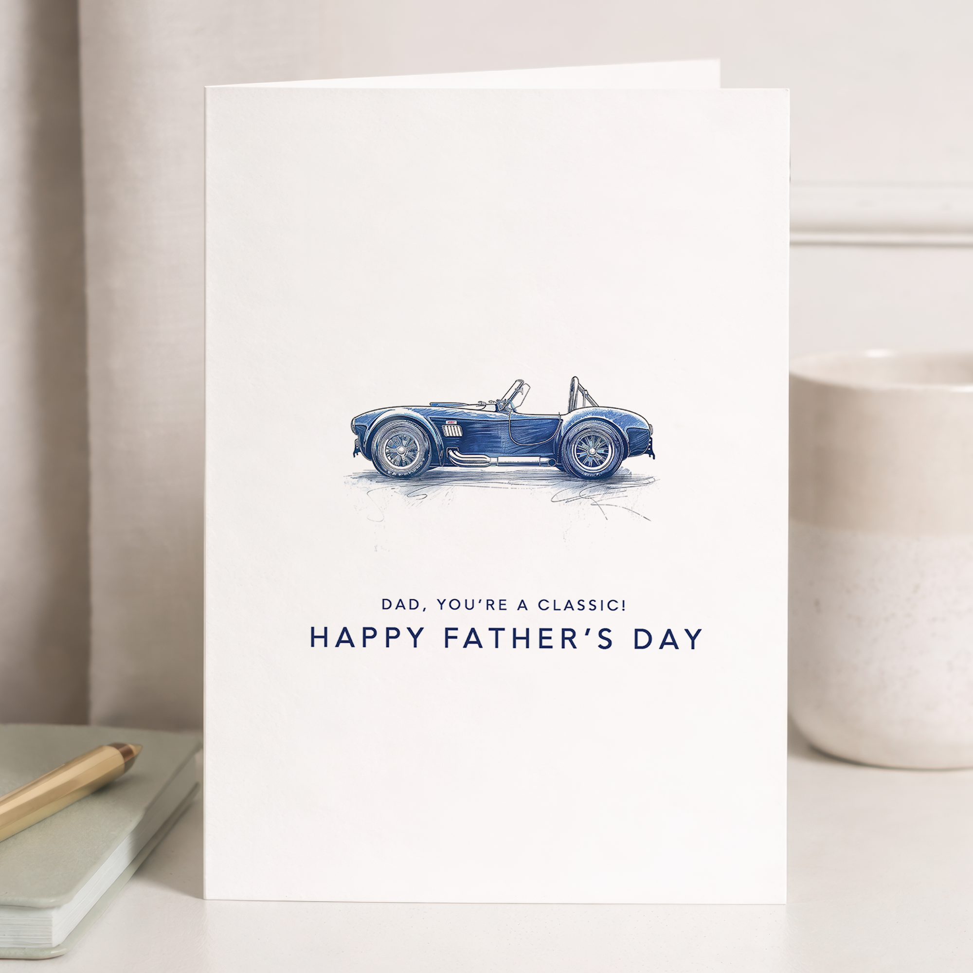 Minimalist Father's Day greeting card featuring a blue and white classic car illustration and the message You're a classic dad.