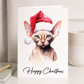 A Sphynx cat wearing a red Santa hat on a Christmas greeting card.