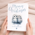 A charming Christmas card featuring two cute owls snuggling together, suitable for a partner, spouse, or loved one.