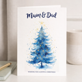 Christmas card featuring a minimalist illustration of a decorated Christmas tree, with a kraft envelope.
