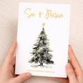 A festive Christmas greeting card featuring a decorated green Christmas tree with a golden star on top, set against a clean background.