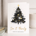 A festive Christmas greeting card featuring an illustration of a decorated green Christmas tree with a golden star on top, set against a dark background with white snowflake patterns and the text Wishing You A Merry Christmas.