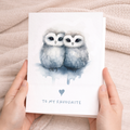 A simple, romantic greeting card featuring two illustrated owls sitting together on a branch, perfect for an anniversary or Valentine's Day.