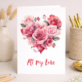 A vibrant floral heart illustration on a white background, featuring red and pink flowers with green leaves, for a Valentine's Day greeting card.