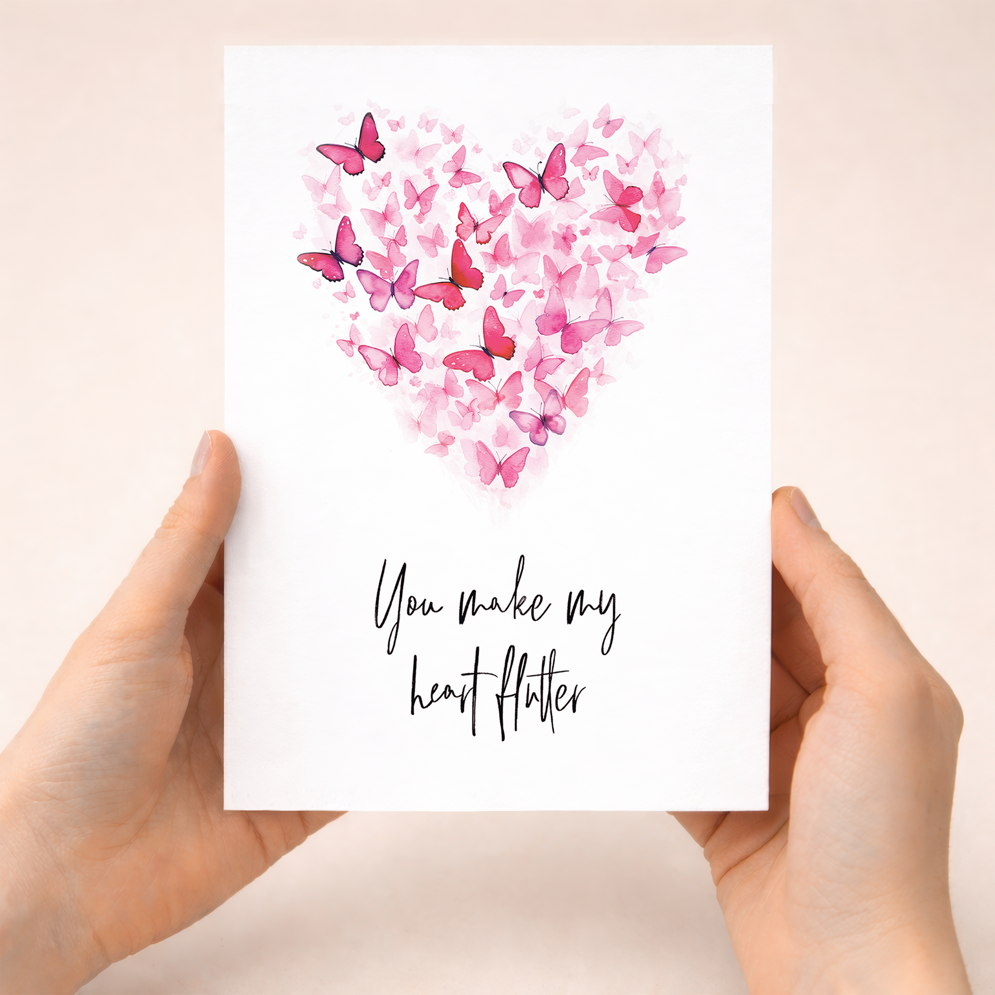 Anniversary greeting card featuring a delicate heart shape composed of various pink, white, and black butterflies on a clean background.