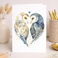 A romantic wedding card featuring an illustration of two barn owls with a heart design on eco-friendly paper.