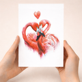 Romantic anniversary card featuring two pink flamingos forming a heart shape with their necks on a white background with red and pink hearts.