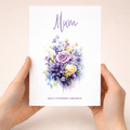 A portrait 5x7 inch birthday card for mum featuring a delicate floral design with purple and white flowers and green foliage.