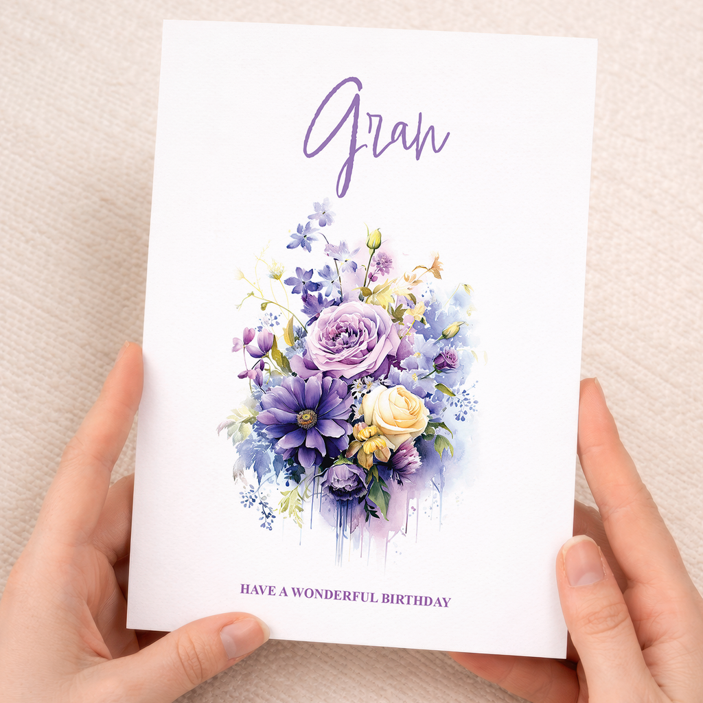 A vibrant birthday card featuring a variety of colorful flowers and botanical illustrations in shades of pink, purple, and blue against a clean white background.
