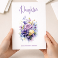 A vibrant floral birthday card for a daughter featuring a mix of purple, pink, and white flowers with a central circular border enclosing the message Happy Birthday Daughter.