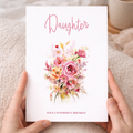 A portrait 5x7 floral birthday card for a daughter featuring a delicate pink and white flower design on a white background, accompanied by a brown kraft envelope.