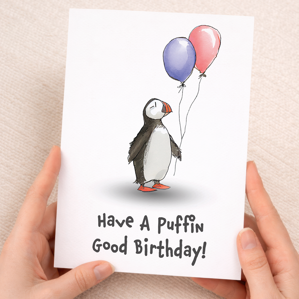 Cute illustrated birthday card for children featuring a happy puffin bird with a colorful party hat on a plain background.