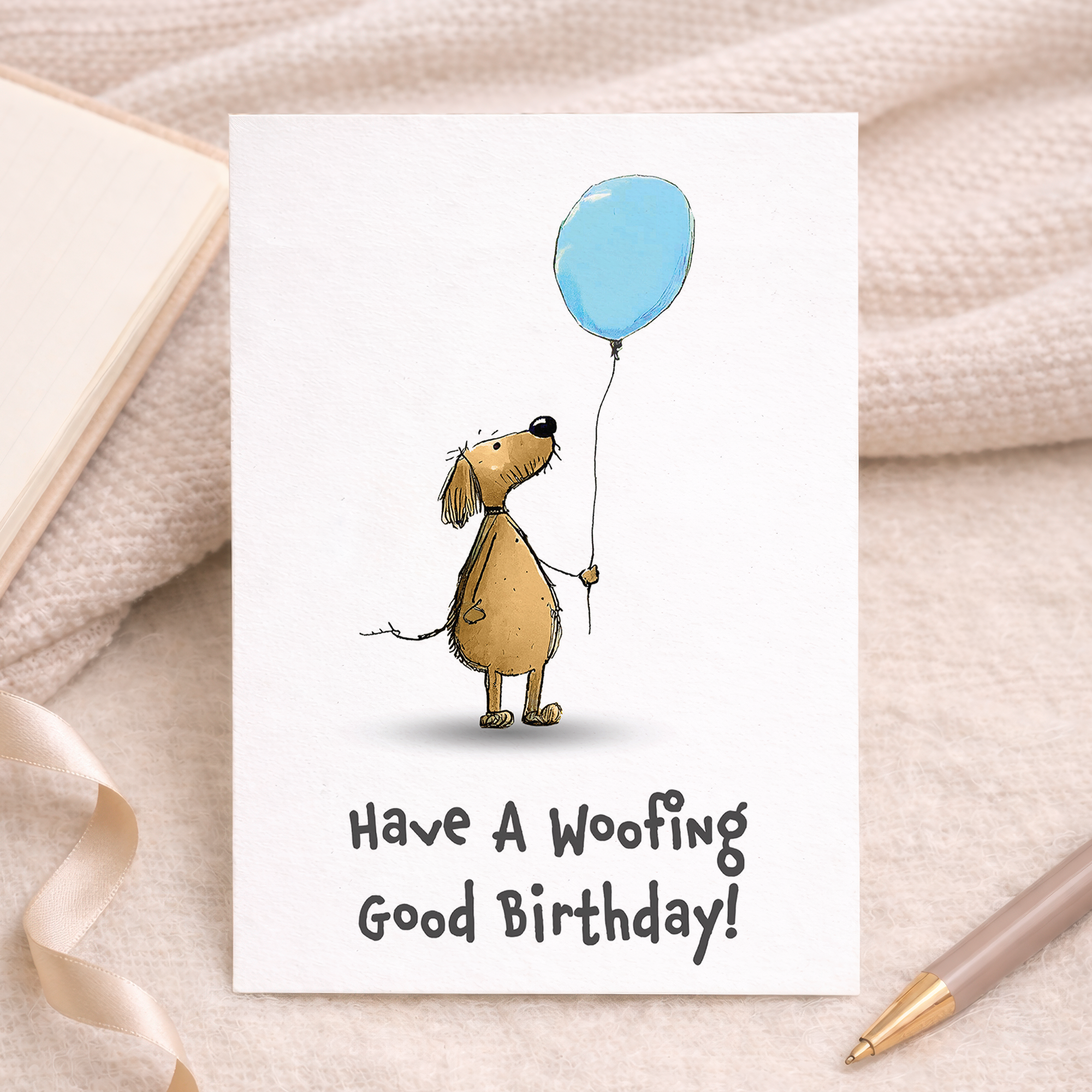 A portrait-oriented birthday card featuring a cute, illustrated brown dog with floppy ears wearing a colorful, polka-dotted party hat. The playful text reads Woofing Good Fun above the dog and Have a Pawsome Birthday below it, set against a clean white background.