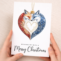 Romantic Christmas card for a wife featuring an illustration of two foxes sitting inside a decorative bauble with a red love heart.