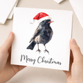 Fun Christmas Card of a Black Bird Wearing A Santa Hat Whimsical Watercolour Christmas Card For Bird Lover For Him or Her