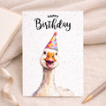Whimsical watercolor illustration of a white goose wearing a colorful party hat on a 5x7 greeting card.
