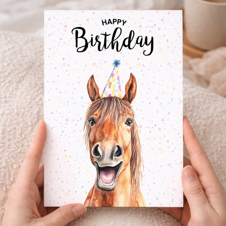 Watercolor illustration of a horse on a white birthday greeting card.