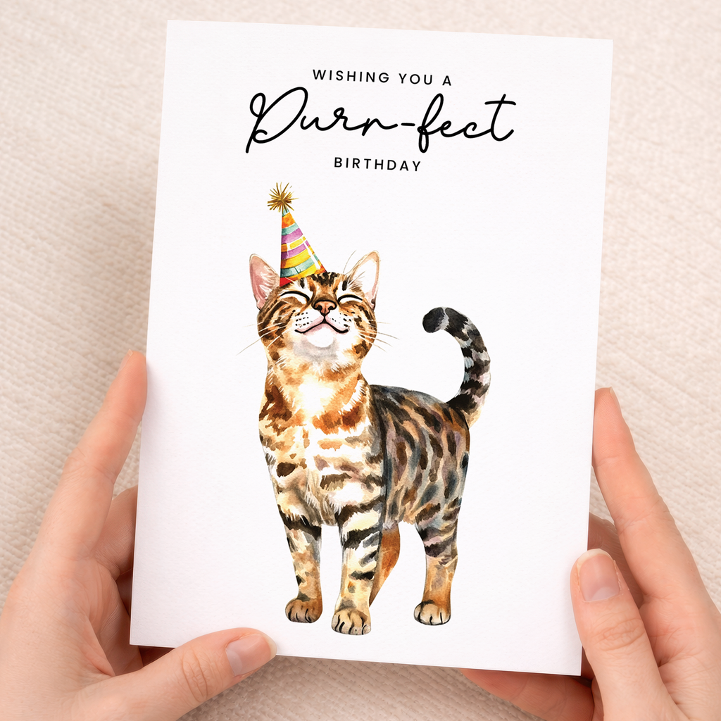 Cute Bengal cat wearing a colorful party hat on a vertical birthday greeting card.