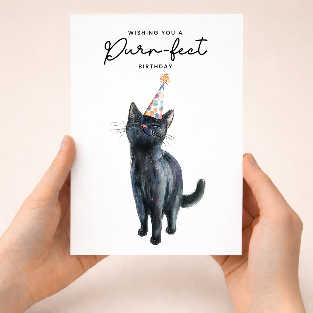 A cute illustration of a black cat wearing a colorful party hat on a white birthday greeting card.